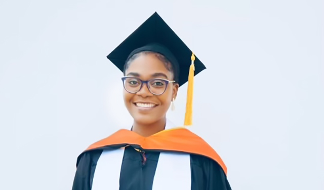 Annel Noel smiling in her graduation regalia. 