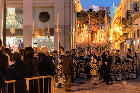 Huelva, Spain. Circa March 2018. Candles illuminate a sculpture depicting virgin Mary on a religious float during Holy Week procession in Huelva at night.