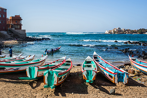 A stock photo of fishing boats in Ngor, Dakar, Senegal.